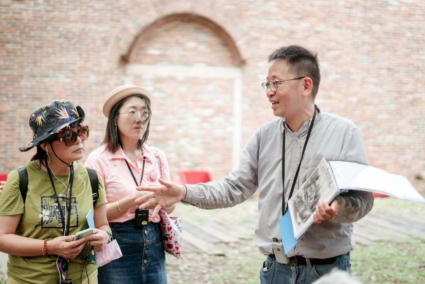 旅學堂導覽員在淡水歷史建築前帶領旅人認識地方故事